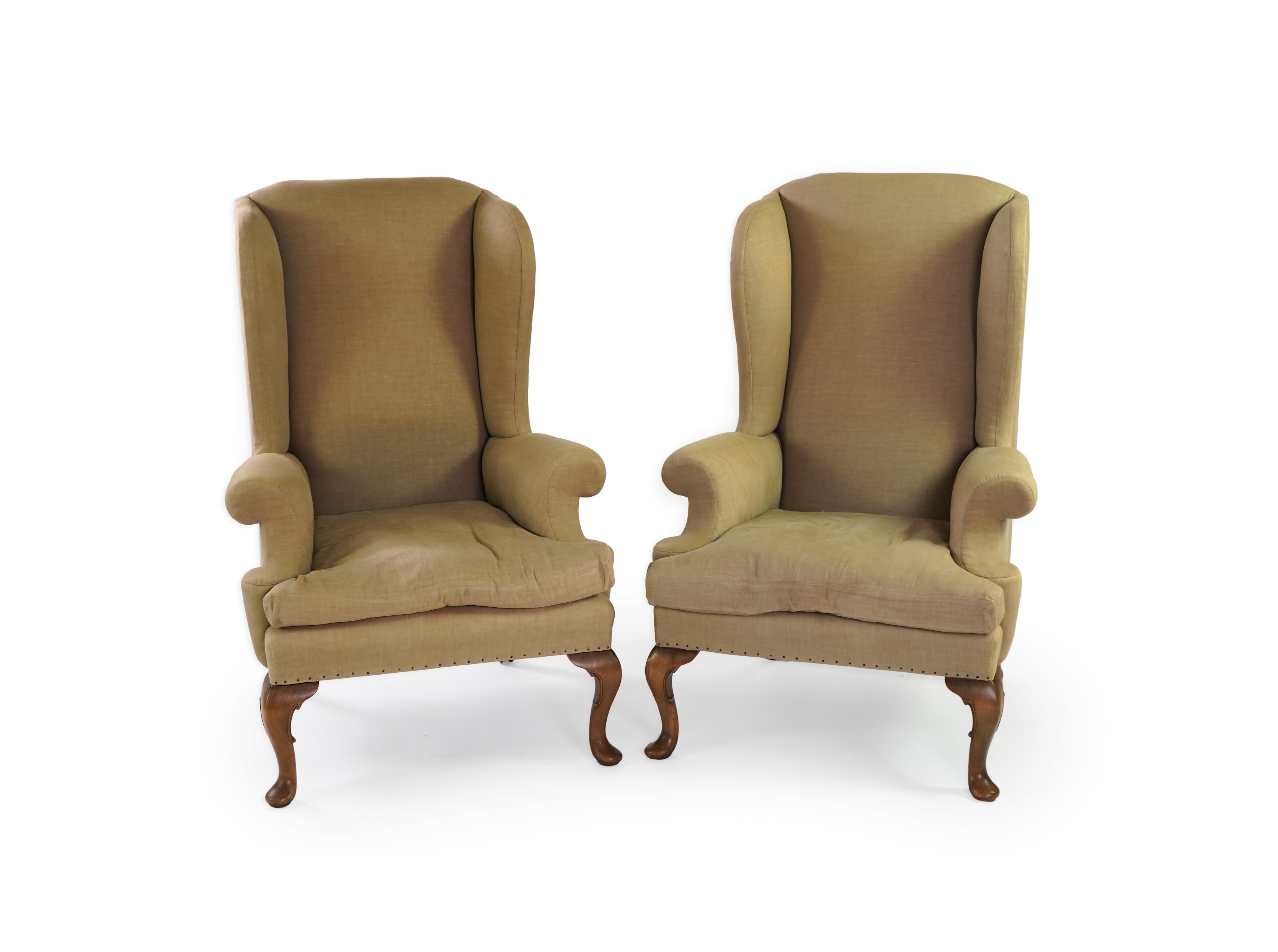 A pair of late 19th / early 20th century George II style upholstered wing armchairs